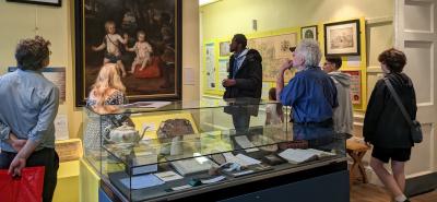 People looking at a painting in a museum gallery