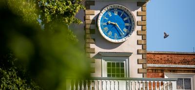 clocktower with foliage in foreground