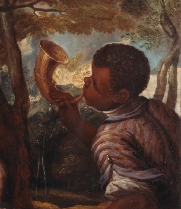 Detail of young boy blowing trumpet