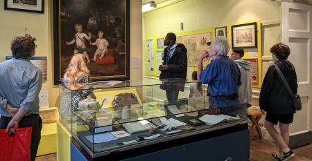 People looking at a painting in a museum gallery
