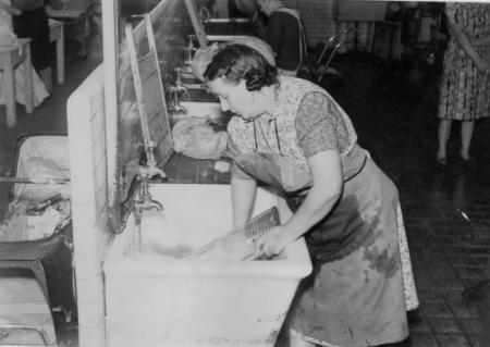 black and white photo of woman at a laundry