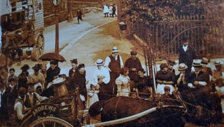 Image of edwardian tottenham with croud gathered round what appears to be a horse drawn milk cart