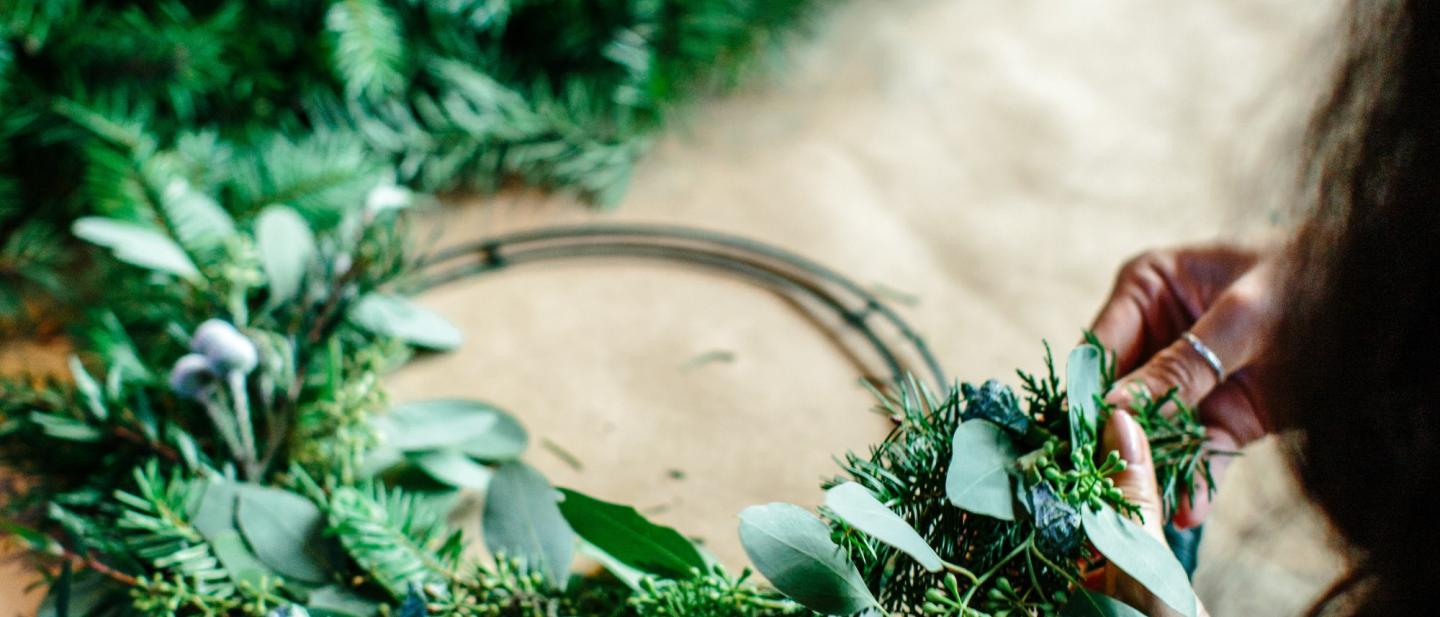 Person making a festive wreath.