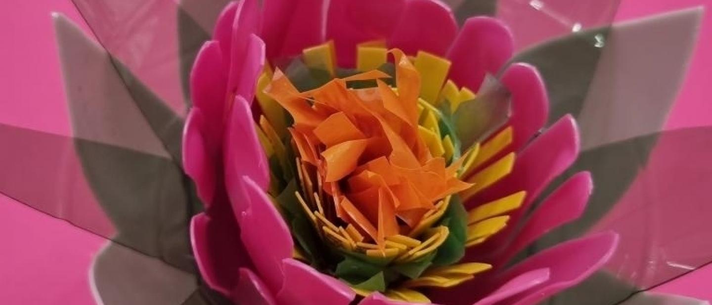 pink, orange and green flower made from recycled plastics