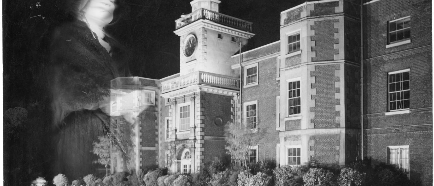 Edited image of a manor house with a ghostly figure in the foreground