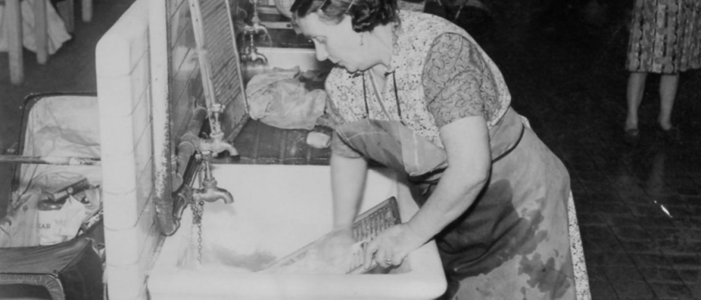 black and white photo of woman at a laundry