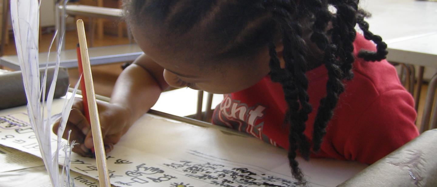 child doing scroll and calligraphy activity 