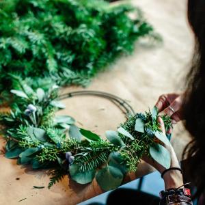 Person making a festive wreath.