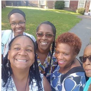 5 women taking a selfie in a park