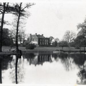 A manor house with a lake in front, from the late 1800s