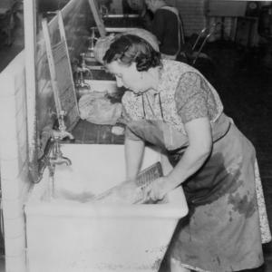 black and white photo of woman at a laundry